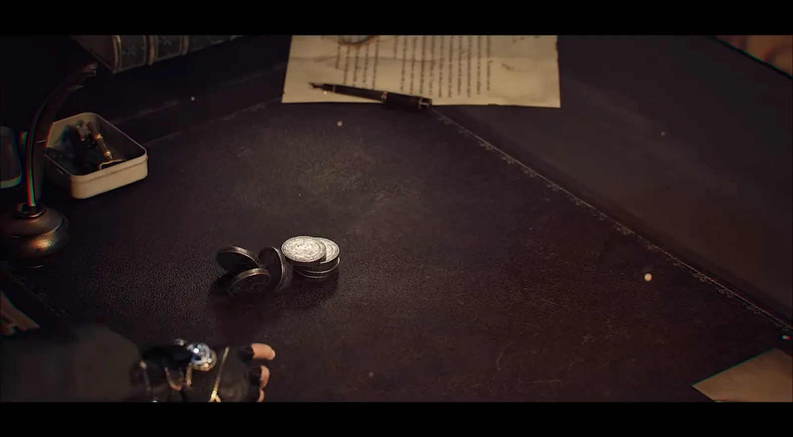 Leather diary and coins on a dark desk